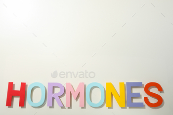 The word hormones on a light background.