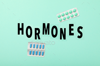 The word hormones on a light background.