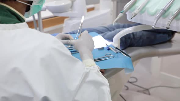Dentist using tools during treatment in clinic