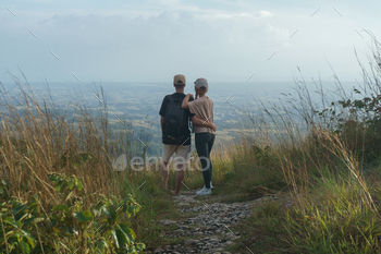 Couple in the mountain watching the sunset