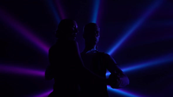 Bottom View of Black Silhouettes Dancing Couple Performing Elements of Argentine Tango