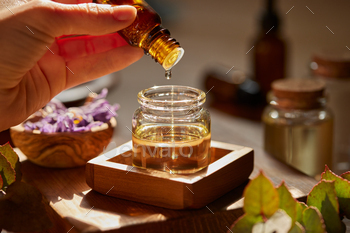 Dropping natural essential oil in a bottle