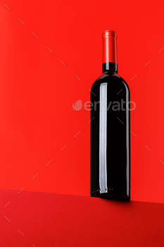Red wine elegance: Wine bottle against vibrant red background