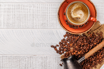 Roasted coffee beans and various espresso coffee cup