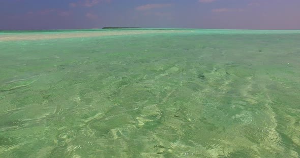 Luxury flying abstract view of a white paradise beach and blue sea background in 4K