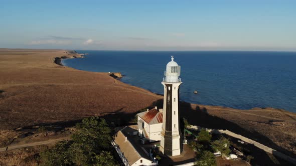 Aerial View of the Coastal Maritime Lighthouse Stands on the Seashore or Ocean