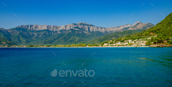 Clear day showcases a beautiful beach with mountains in Thassos, Greece