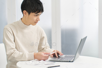 A man entering expenses into accounting software