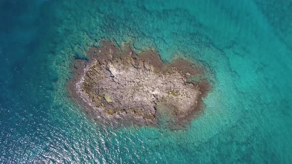 Aerial top view of a little island in the sea