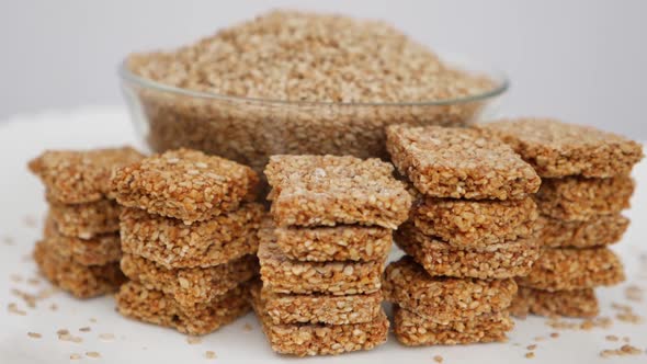 Rotating shot of a bowl filled with sesame seeds and sesame seeds around