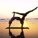 Fit Sporty Couple Practicing Acro Yoga with Partner Together on the Sandy Beach - VideoHive Item for Sale