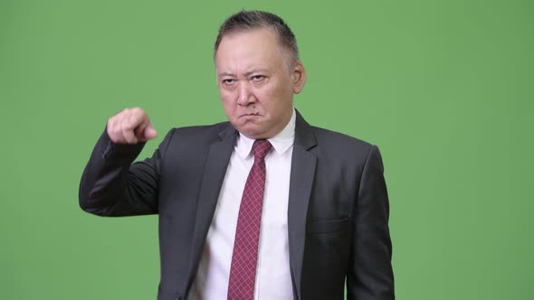 Mature Angry Japanese Businessman Pointing Finger