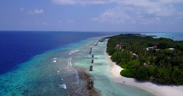 Beautiful above tourism shot of a white paradise beach and blue sea background in high resolution 4K