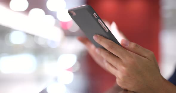 Woman use of mobile phone in shopping mall