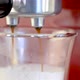 Closeup shot of a coffee machine filling two white cups in HD - VideoHive Item for Sale