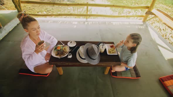 The Happy Family Eat and Drink Tasty Beverages Spending Time in Local Floating Cafe on Water