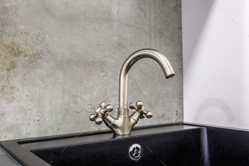 steel water tap sink with faucet in expensive loft kitchen