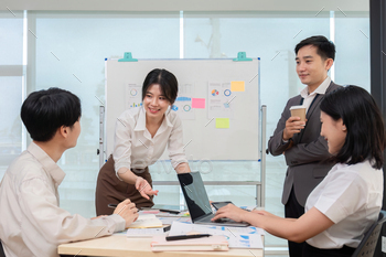 A team of Asian businessmen meets to brainstorm ideas about office work management in an office