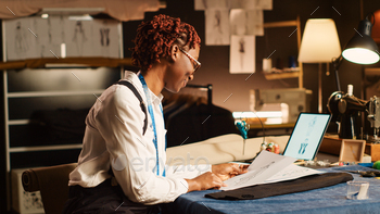 African american tailor reviewing sketch