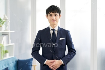 A businessman wearing a custom suit and saying hello