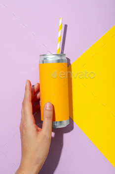 A metal can with an orange wrapper with a tube