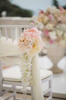 wedding decorations flowers on chairs. Wedding exit registration, white chairs decorated for wedding