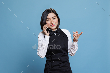 Waitress managing conversation on phone