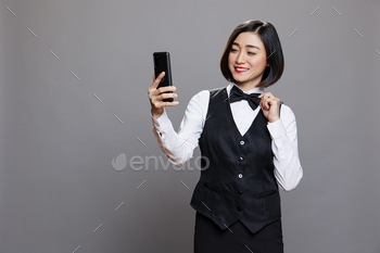 Waitress chatting in video call on phone