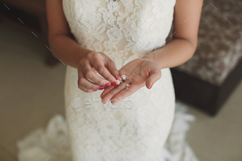 Wedding rings in hands of the bride