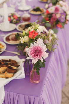 The flowers at the wedding table. Tent.