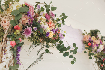 Wedding arch decorated with fresh flowers.