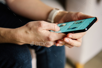 Person Browsing Social Media on Smartphone Indoors