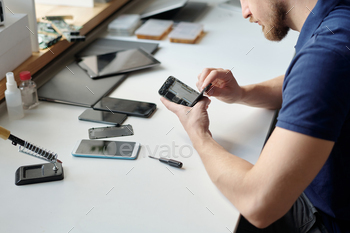 Repair center engineer checking battery