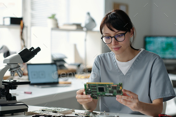 Technician checking computer motherboard