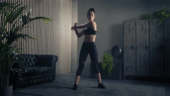 Sweaty and Tired Sporty Brunette Woman Stretching After Intense Workout at Home