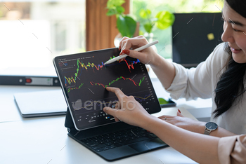 Financial analyst using a tablet to study market trends. Investment and stock market concept.
