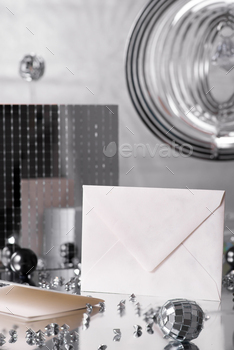 Envelope mockup and silver decorations on silver background , copy space