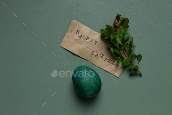 easter card, green egg, boxwood branch, typewritten text , happy easter,