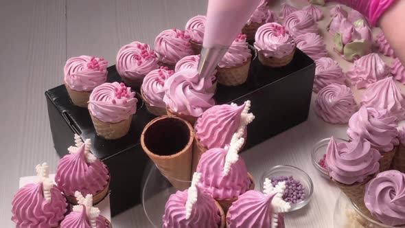 A Woman Fills Waffle Cones With Marshmallows. With A Pastry Bag.