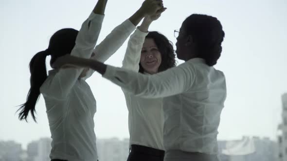 Cheerful Multiethnic Businesswomen Dancing