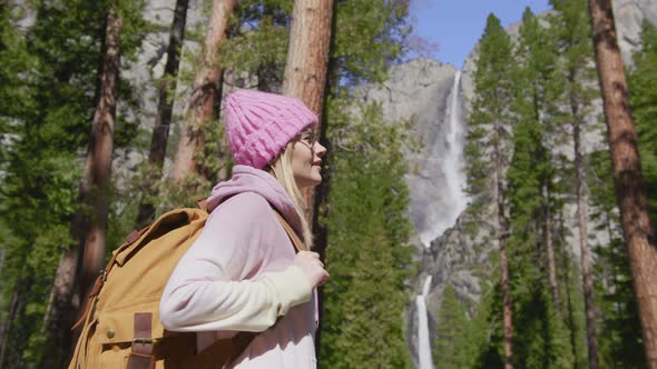 Slow Motion Smiling Woman Enjoying Pine Forest with Waterfall View RED Footage