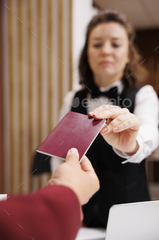 Hotel concierge checks passport