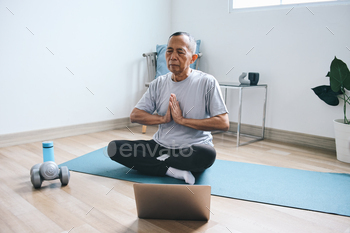 Senior Man Doing Yoga with Online Instruction