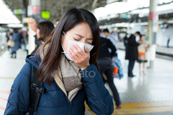 Woman feeling sick in train platform