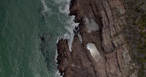 4k Top Down Drone Shot moving over Rocky Coast Line Near Kogel Bay, Western Cape, South Africa