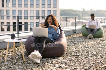 African female freelancer beginning video conference via internet connection.