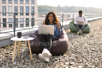African female freelancer beginning video conference via internet connection.
