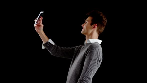 Androgynous man taking a selfie on mobile phone