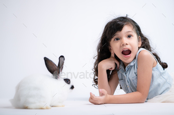 Smiling little girl and with their beloved rabbit, showcasing the beauty of friendship
