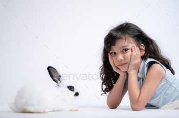Smiling little girl and with their beloved rabbit, showcasing the beauty of friendship